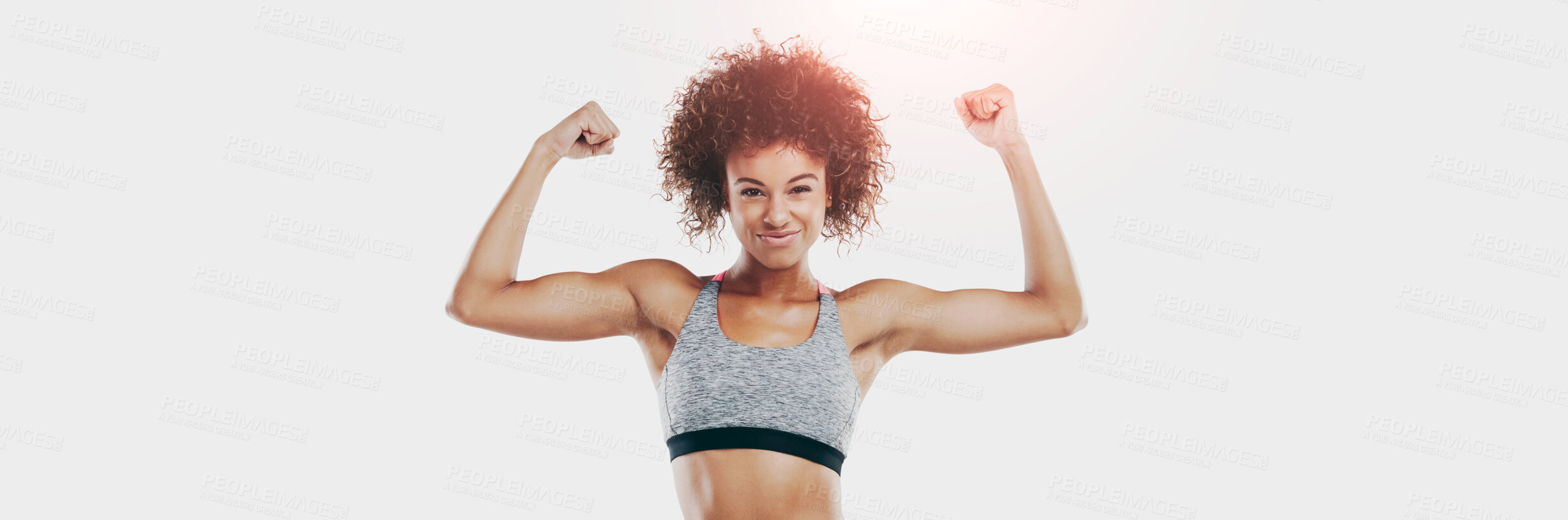 Buy stock photo Studio shot of a fit young woman flexing her muscles against a white background