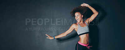 Buy stock photo Shot of a sporty young woman jumping against a grey background