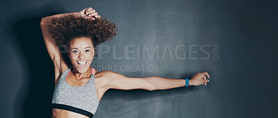 Buy stock photo Shot of a sporty young woman jumping against a grey background