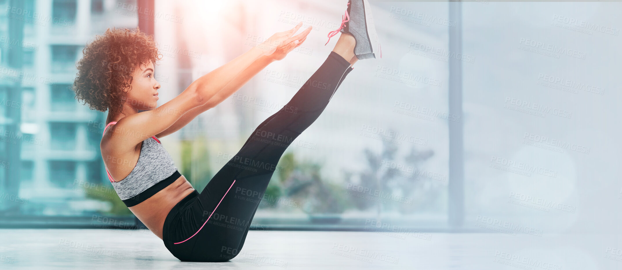 Buy stock photo Shot of a sporty young woman working out in a studio