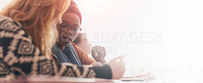 Buy stock photo Cropped shot of two university students having a discussion in class