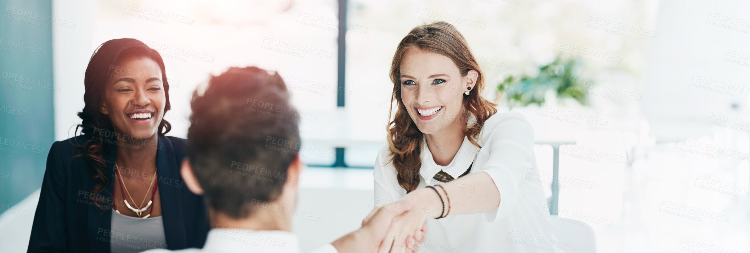 Buy stock photo Cropped shot of a man being interviewed by two businesswomen in an office