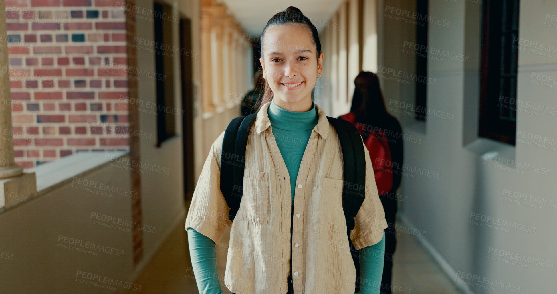 Buy stock photo Happy, hallway and portrait of girl at academy with backpack for learning, studying or knowledge. Smile, teenager and student from Portugal in corridor of school for education class with scholarship.