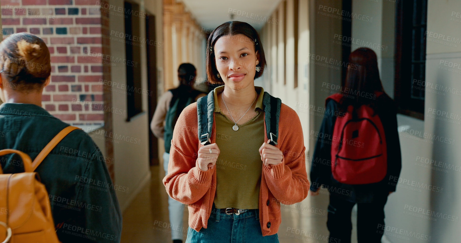 Buy stock photo Happy, hallway and portrait of girl at school with backpack for learning, studying or knowledge. Smile, teenager and student from Brazil in corridor of academy for education class with scholarship.