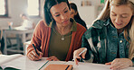 Education, help and friends writing notes in classroom with studying for test, exam or assignment. Learning, girls and students working on team project together with books for information at academy.