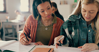 Buy stock photo Education, help and friends writing notes in classroom with studying for test, exam or assignment. Learning, girls and students working on team project together with books for information at academy.