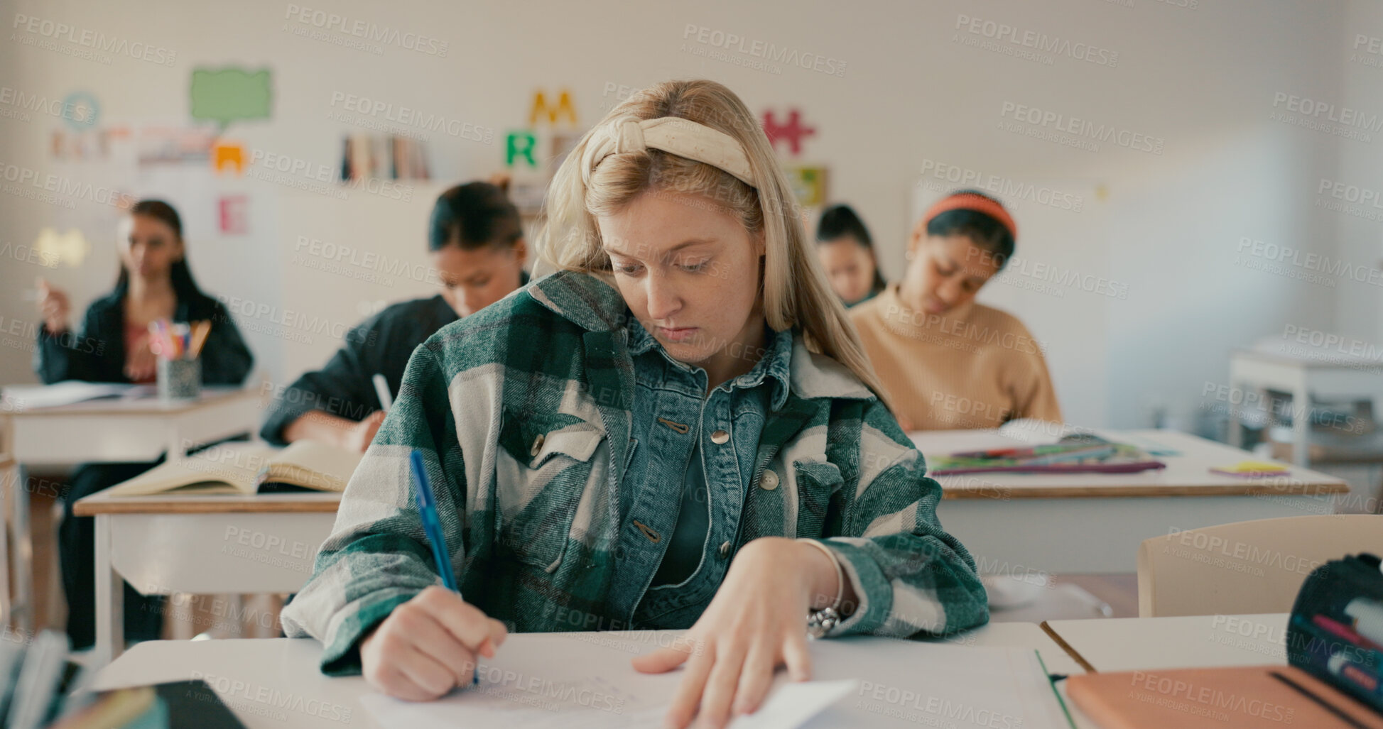 Buy stock photo Writing, test and education with girl in classroom for learning, entrance exam and scholarship. Academy, knowledge and future with student in high school for solution, studying and problem solving