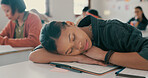 Exhausted, sleeping and student on desk in classroom at school with fatigue in lesson for learning. Burnout, rest and girl teenager with nap for tired with education, learning or studying for exam.