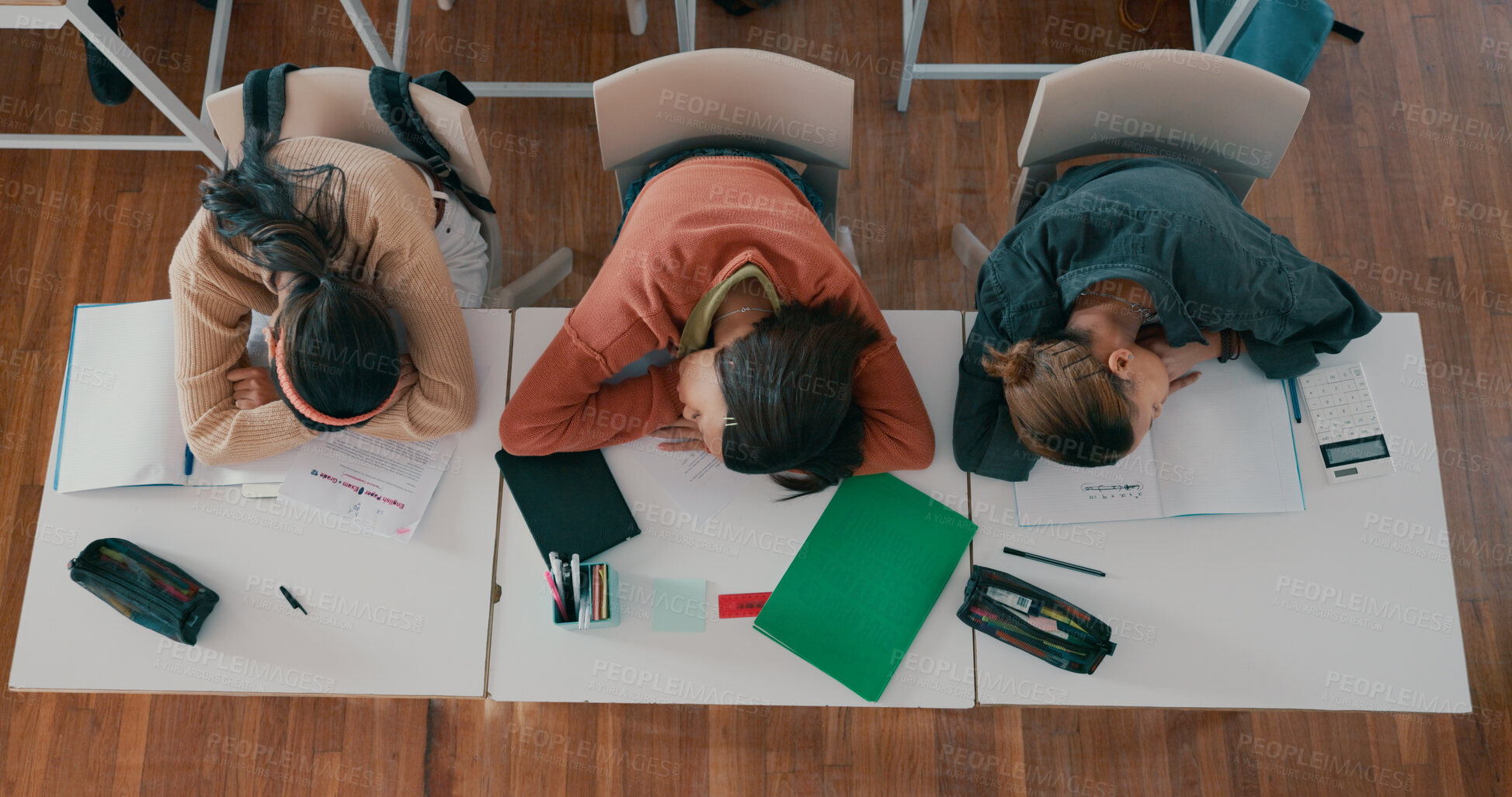 Buy stock photo Tired, sleeping and students on desk in classroom at school with fatigue in lesson for learning. Burnout, rest and group of teenagers with nap for exhaustion with education, learning or studying.