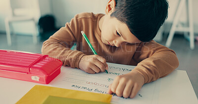 Buy stock photo Boy, child and writing with paper at school for education, learning and assessment for progress at academy. Kid, quiz and activity for development, scholarship and thinking with language in classroom