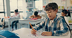 Desk, kid and boy drawing in classroom with notebook, growth and development in education. Study, thinking and child with color pencil, stationery and books for creative learning at elementary school