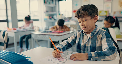 Buy stock photo Desk, kid and boy drawing in classroom with notebook, growth and development in education. Study, thinking and child with color pencil, stationery and books for creative learning at elementary school