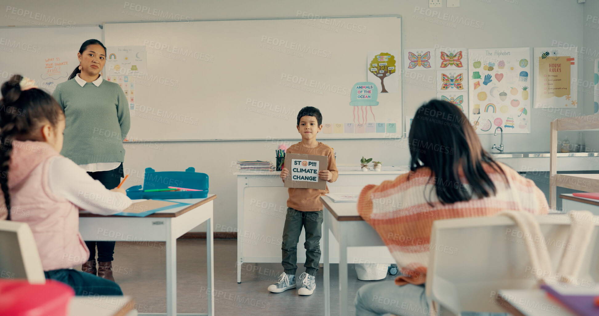 Buy stock photo Boy, child and presentation with poster in classroom to stop climate change with info, opinion and speech. Kid, sign and assessment for public speaking with activism for global warming at school