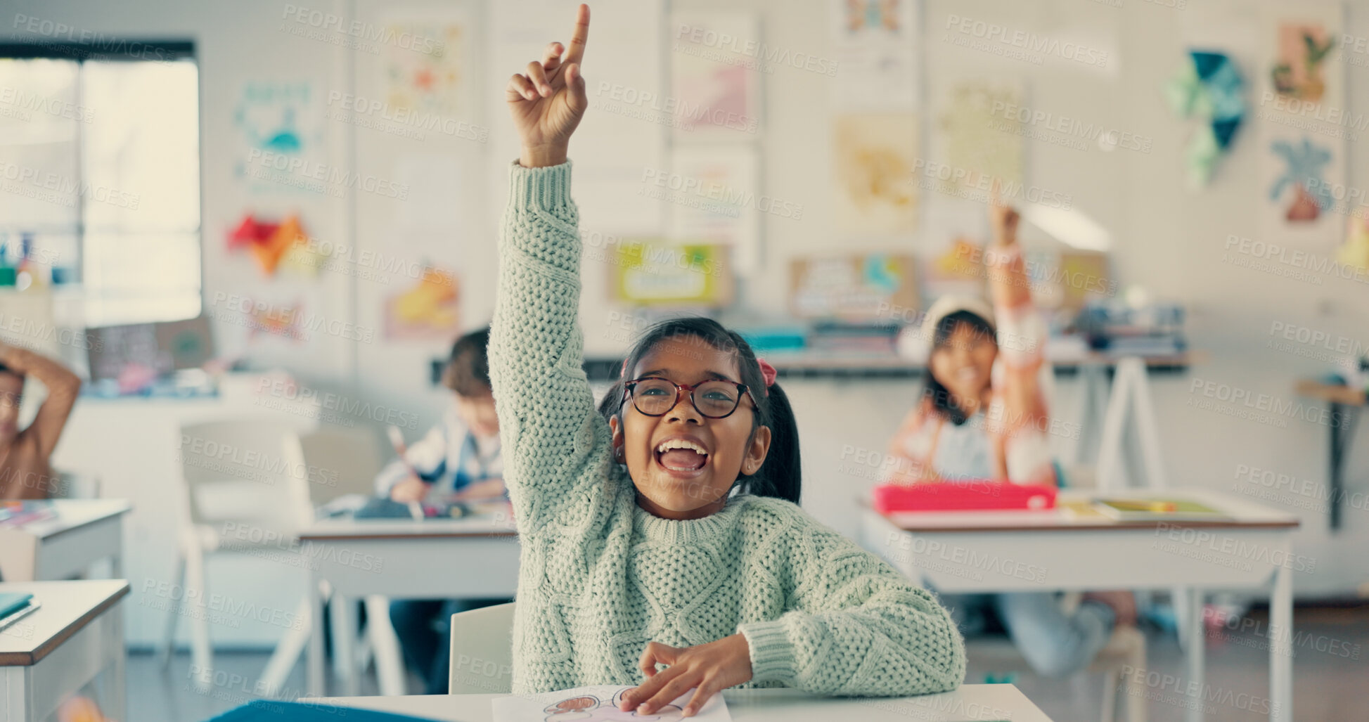 Buy stock photo Girl, child and happy with raised hand in classroom for question, answer and excited with solution for quiz. Kid, smile and sign for problem solving, learning and assessment for education at school