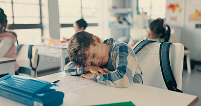 Buy stock photo Boy, child and tired with sleeping in classroom with learning, dream and fatigue at academy. Kid, lazy and rest with  paper, scholarship and burnout for education, development or creative at school