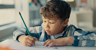 Buy stock photo Boy, child and writing with paper in classroom for education, learning and assessment for progress at academy. Kid, quiz and activity for development, scholarship and thinking with language at school