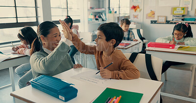 Buy stock photo Happy boy, classroom and high five with teacher for education, learning or winning at school. Young, child or kid with smile or touching hands for exam, test or success in assessment or assignment