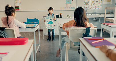 Buy stock photo Young boy, classroom and presentation with poster for global warming, ocean conservation or awareness at school. Young kid, child or elementary student with sign or page to save eco friendly planet