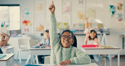 Buy stock photo Girl, child and excited with raised hand in classroom for question, answer and happy with solution for quiz. Kid, smile and nerd for problem solving, learning and assessment for education at school