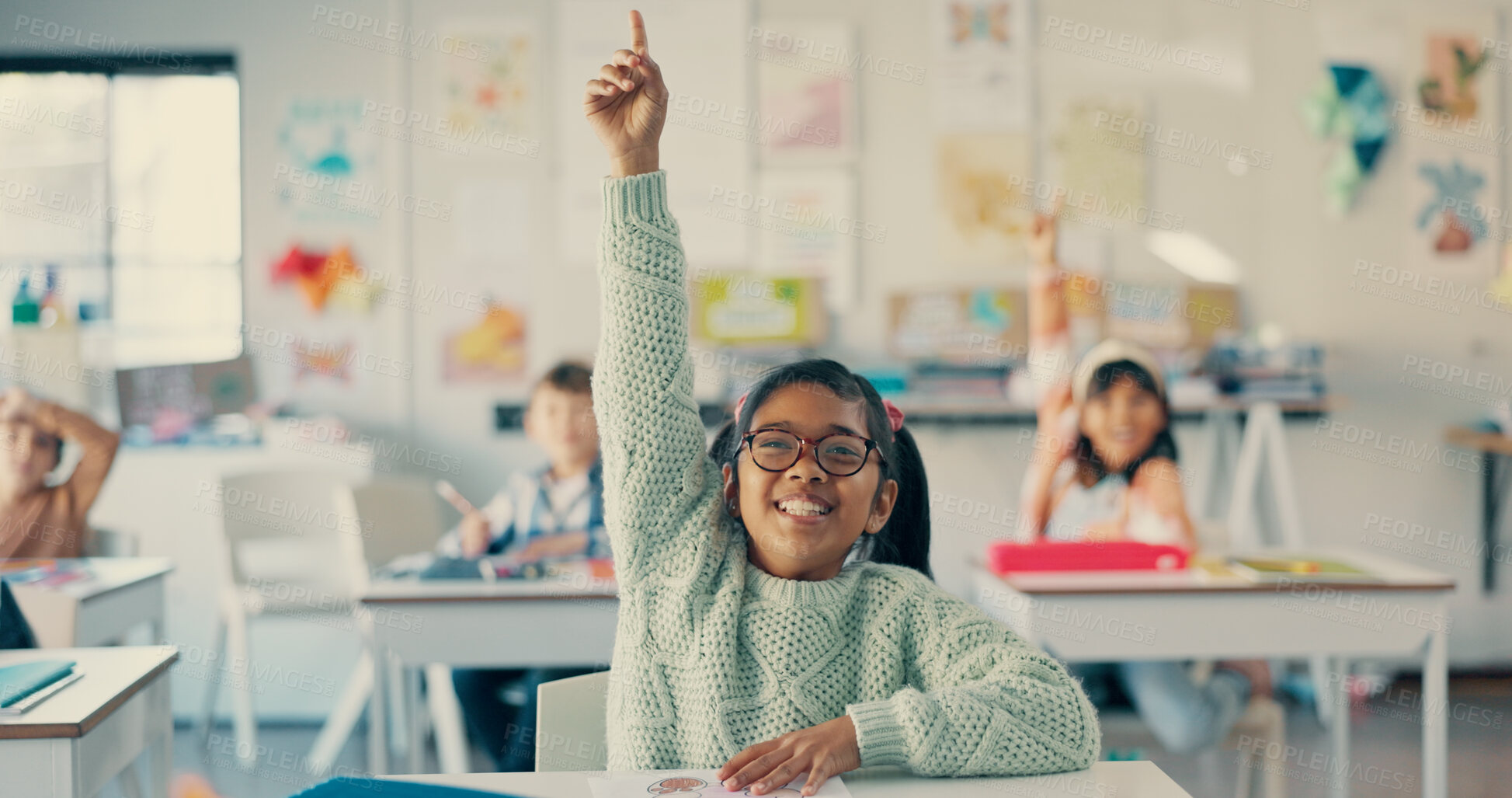 Buy stock photo Girl, child and excited with raised hand in classroom for question, answer and happy with solution for quiz. Kid, smile and nerd for problem solving, learning and assessment for education at school