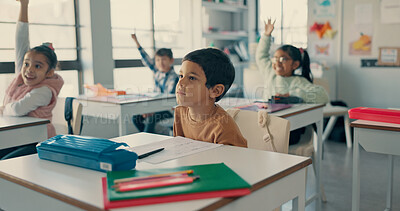Buy stock photo Boy, child and listening with attention in classroom for learning in group with raised hand for question. School kids, test or quiz for scholarship, assessment or education for development at academy