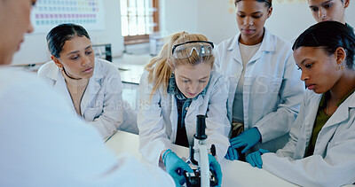 Buy stock photo Students, group and microscope in science classroom for chemistry analysis, sample study or practical lesson. High school, people or learning of medical research for experiment with ppe safety in lab