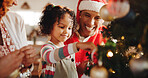 Christmas, decoration and smile with family and tree for festive magic, Noel cheer and xmas celebration. Star, winter holiday and love with people at home for present, vacation and helping together