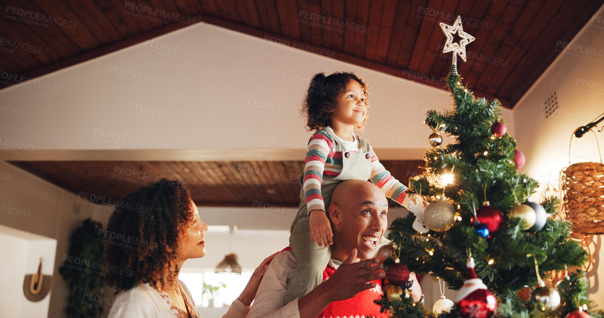 Buy stock photo Christmas, decoration and star with family and tree for festive magic, Noel cheer and xmas celebration. Tradition, winter holiday and child with people at home for present, vacation and help together