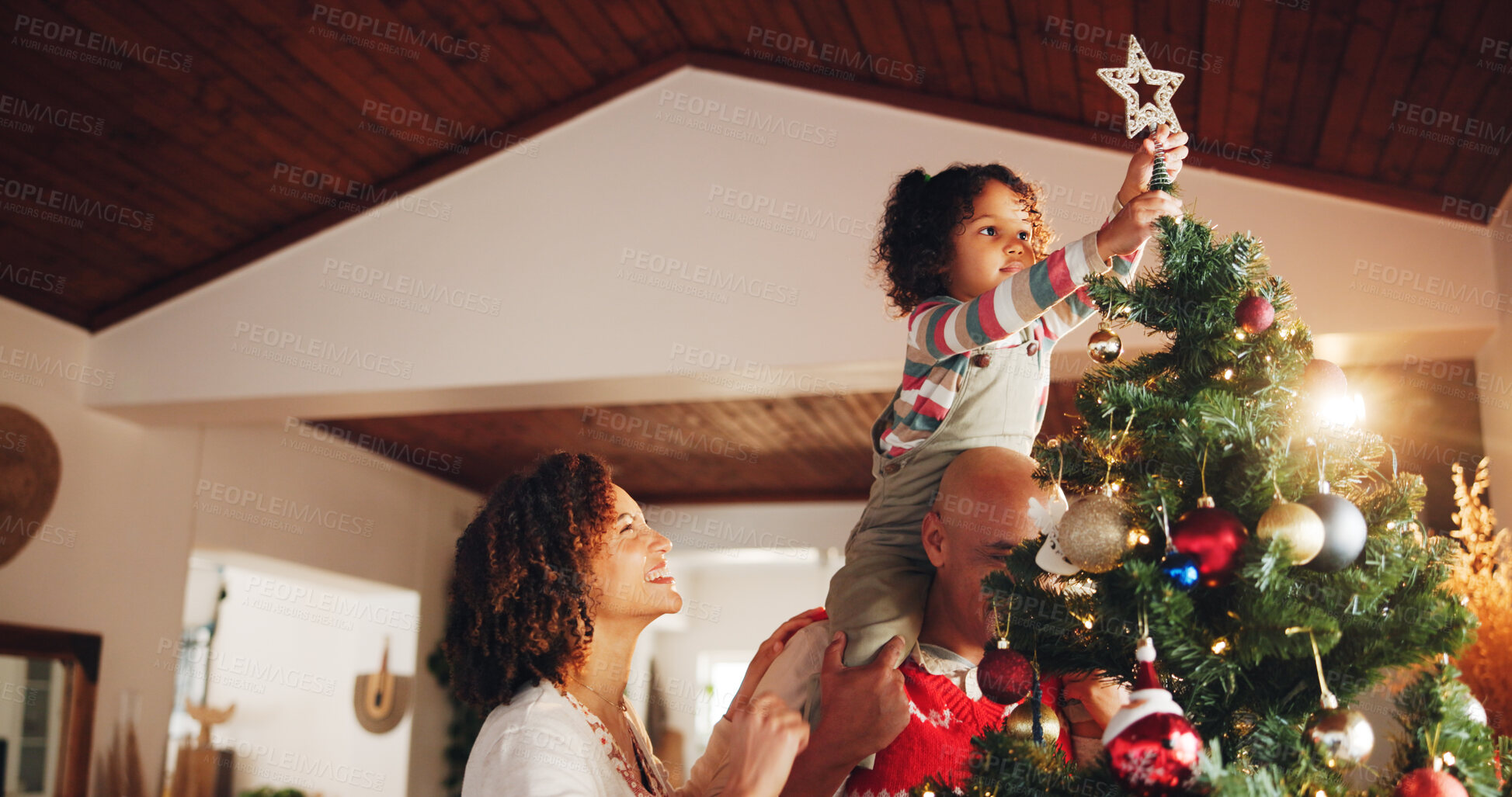 Buy stock photo Christmas, decoration and love with family and tree for festive magic, Noel cheer and xmas celebration. Star, winter holiday and tradition with people at home for present, vacation and child lifting