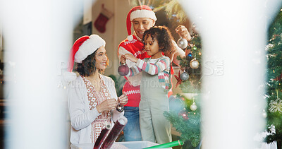 Buy stock photo Christmas, decoration and bauble with family and tree for festive magic, Noel cheer and xmas celebration. Tradition, winter holiday and love with people at home for present, vacation and helping