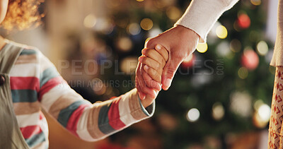 Buy stock photo Christmas, holding hands and parents with child in home for holiday, vacation and festive season. Family, love and closeup of kid for celebration, party and tradition with decoration in living room