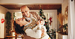 Christmas, happy and couple in home dance for holiday, vacation and festive season. Love, marriage and man and woman laughing for celebration, bonding and tradition with decoration in living room