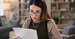 Thinking, woman and reading with paperwork in home loan payment, financial bills or bank statement. Female person,  planning and glasses with document for credit card debt, invoice or investment info