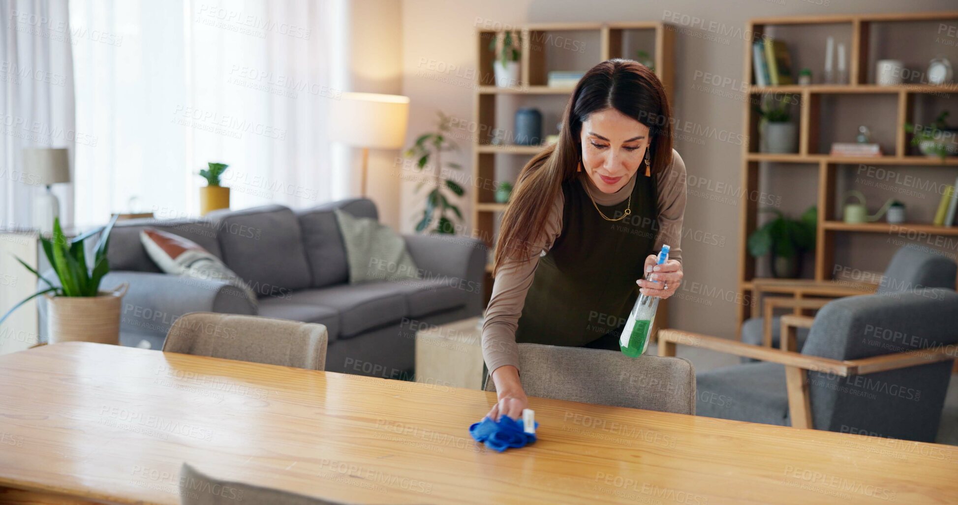 Buy stock photo Woman, disinfectant and wipe table in home for cleaning service, housekeeping and remove dust. Cleaner, person and chemical spray for dirty surface, germs prevention or bacteria with hygiene in house