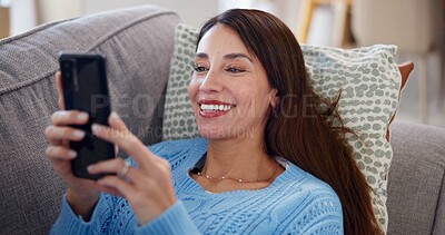 Buy stock photo Woman, smartphone and relax on sofa in home with social media post, streaming subscription and online videos. Person, happy and phone on couch for reading ebook, dating site or browsing internet blog