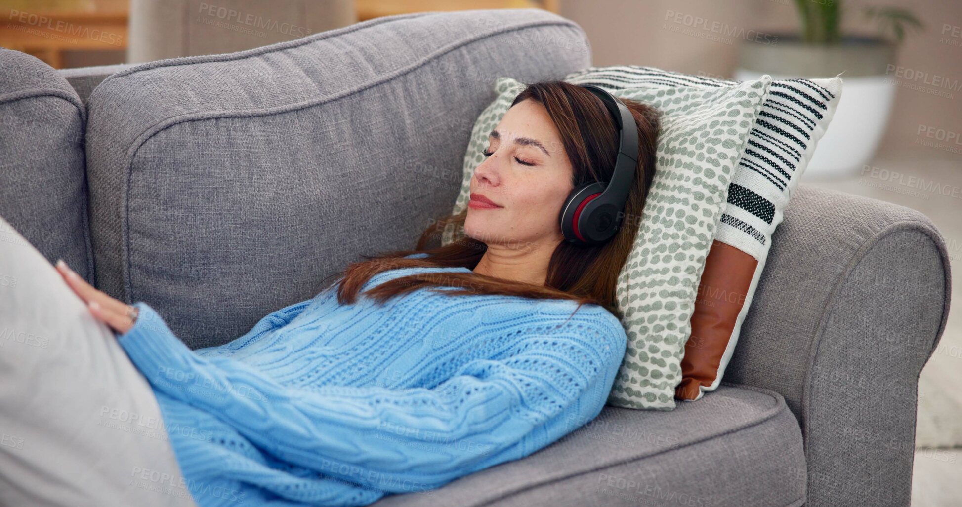 Buy stock photo Woman, relax and sleeping with headphones on sofa for online, subscription and listening to sound. Calm, audio and person with tech in living room for mindfulness, podcast or peace at home on weekend