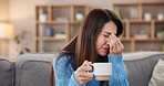 Woman, coffee or headache on sofa in home with brain fog, insomnia or muscle tension. Person, migraine or uncomfortable pressure with stress, temple massage or overwhelmed with burnout in living room