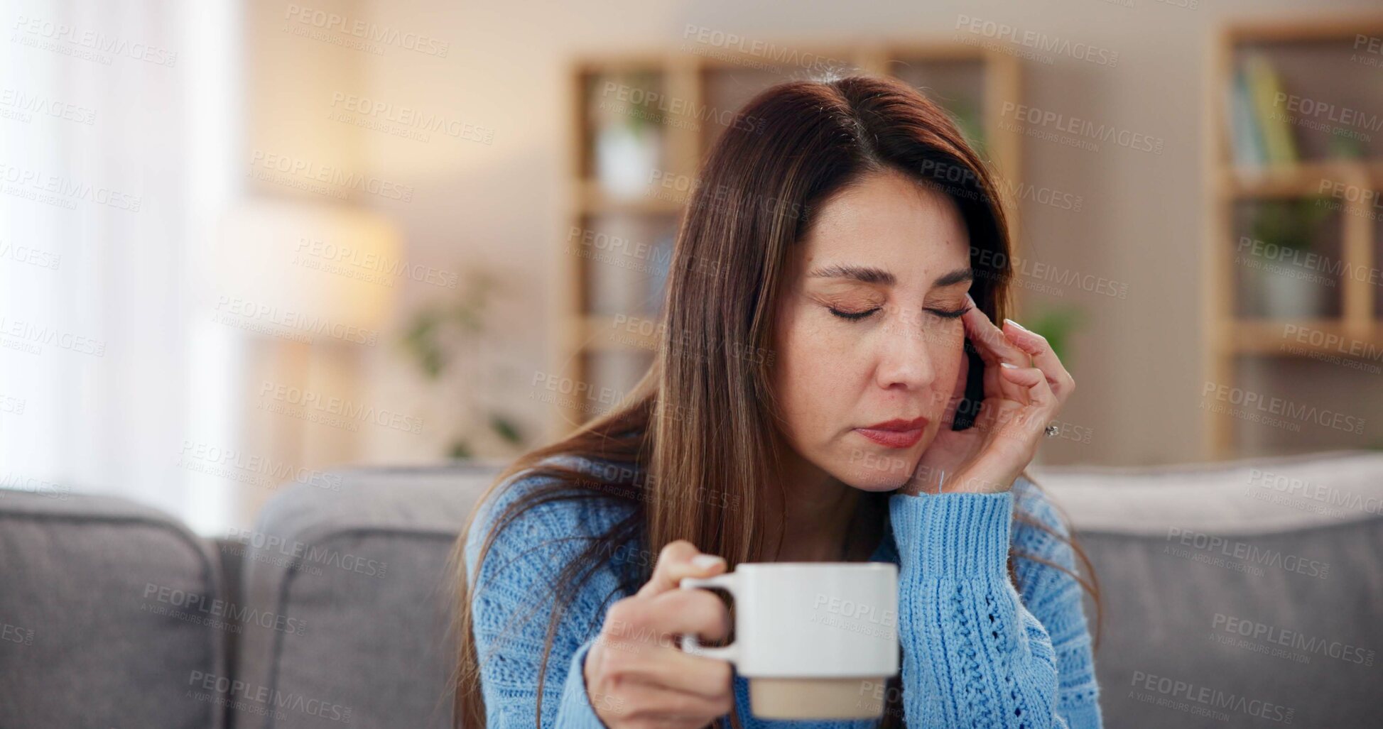 Buy stock photo Woman, coffee and headache on couch in home with brain fog, insomnia or muscle tension. Person, migraine or uncomfortable pressure with ache, temple massage or overwhelmed with burnout in living room