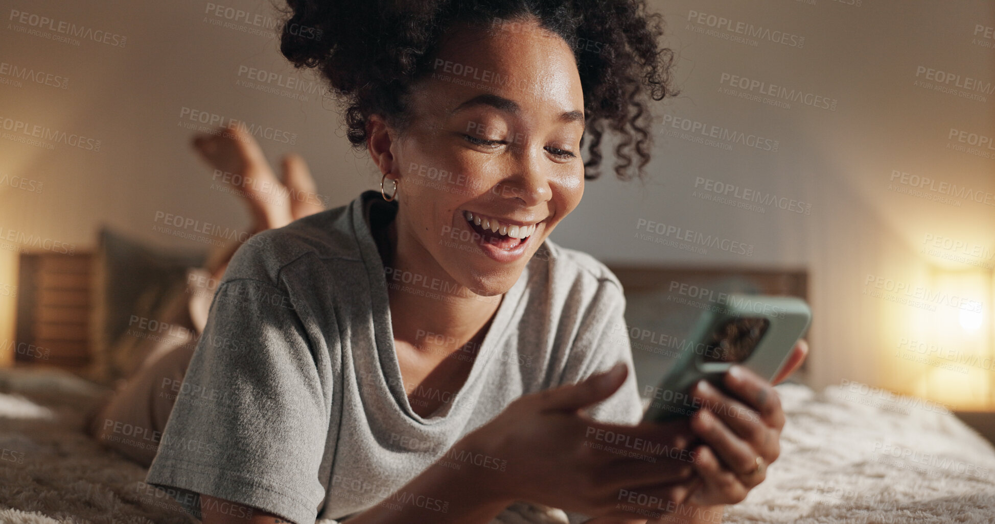 Buy stock photo Woman, laughing and phone on bed for social media surfing in home, typing message and notification. Female person, bedroom and online for communication, reading funny ebook and relax in apartment