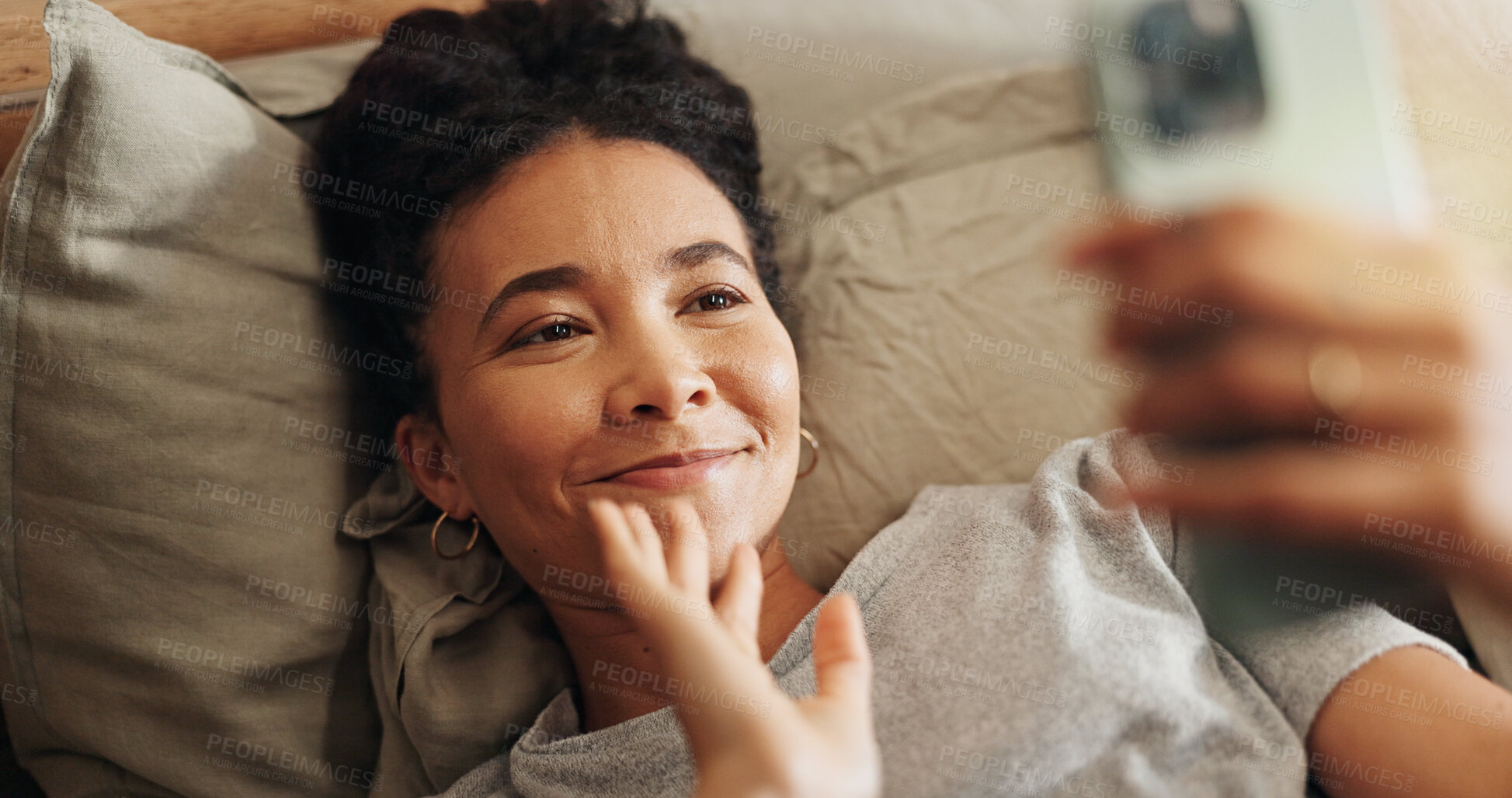 Buy stock photo Woman, waving and phone for video call in home, communication and online for talking in bedroom. Female person, internet connection and virtual conference in bed, comfortable and app for conversation