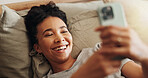 Woman, laughing and phone on bed for internet surfing in home, typing message and notification. Female person, bedroom and online for communication, reading funny ebook and weekend in apartment