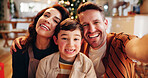 Family, portrait and selfie in home for Christmas, celebration and social media with holiday and hug. Parents, boy and happy people in living room for memory, profile picture or vacation with embrace