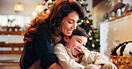 Christmas, house and hug with mother, boy and bonding together with joy, decoration and care in lounge. Xmas tree, family and parent with son, embrace and love with happiness, holiday and festive