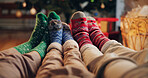 Christmas, socks and feet of family, home and bonding for holiday, season and celebration in lounge. House, legs and parents with child, living room and together for festive, relax and people