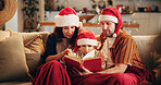 Christmas, family and book in home for reading, learning and traditional literature for religious education. Parents, child and Bible on sofa for storytelling, Christianity and comfort in living room