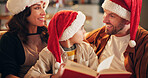 Christmas, happy family and book on sofa for learning, reading and traditional literature for religious education. Parents, child or Bible in home for storytelling, Christianity or comfort with smile