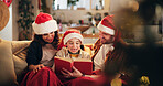 Christmas, family and happy on sofa with book, funny storytelling and reading together. Parents, child and support in home with novel, literature humor and love at festive season with comedy on couch