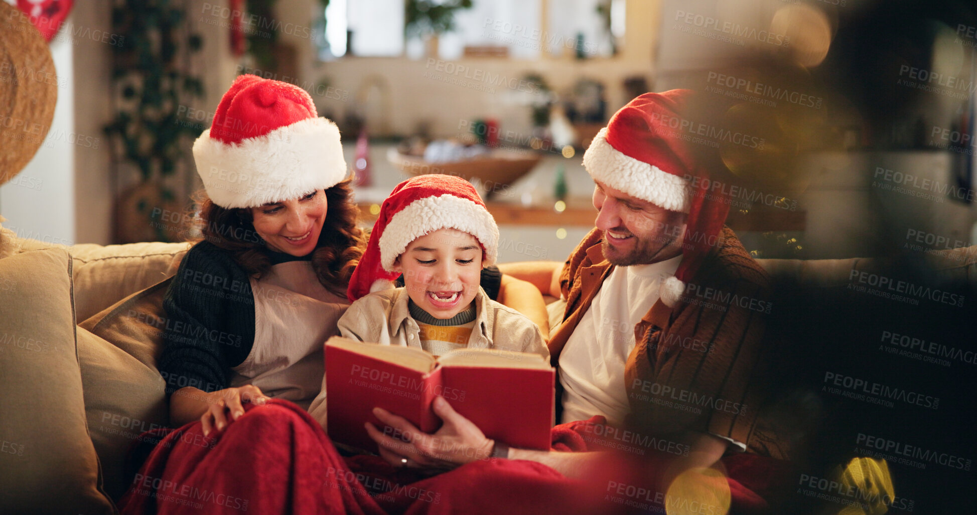 Buy stock photo Christmas, family and happy on sofa with book, funny storytelling and reading together. Parents, child and support in home with novel, literature humor and love at festive season with comedy on couch