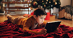 Christmas, house and boy on floor, tablet and typing with internet, connection and social media. Xmas tree, childhood and kid with tech, digital app and online game. with break, festive and holiday