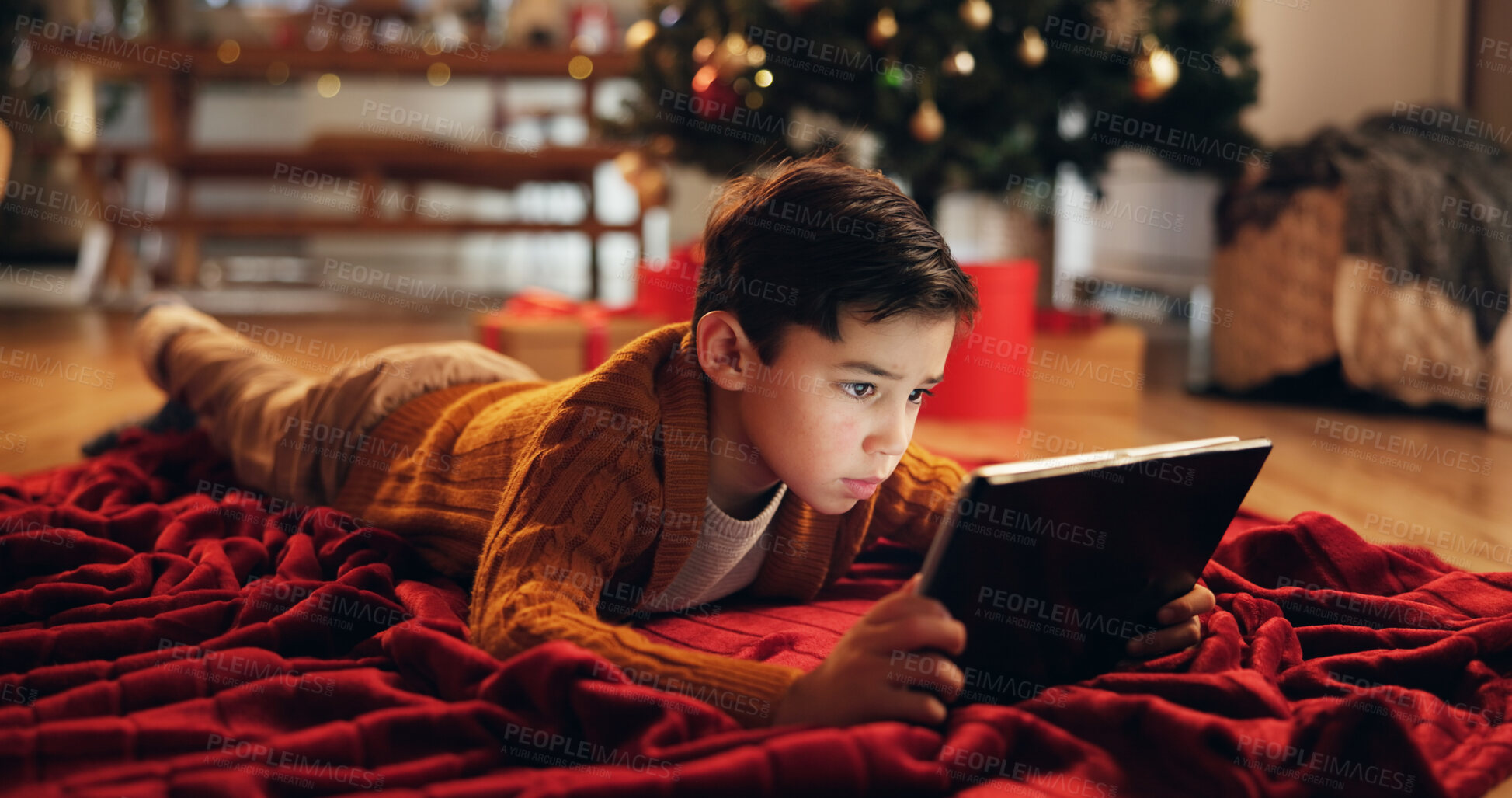 Buy stock photo Christmas, house and boy on floor, tablet and typing with internet, connection and social media. Xmas tree, childhood and kid with tech, digital app and online game with break, festive and holiday